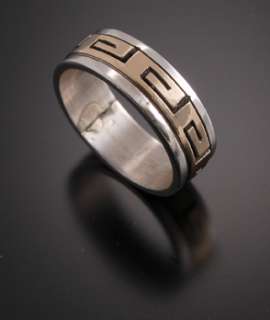 This ring is handmade out of sterling silver and 14k gold.