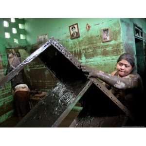  A Woman Tries to Salvage Belongings from Her Flooded House 