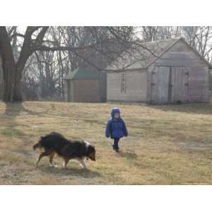  A Young Male and His Sheltie Dog Walk Through a Historic Farm 