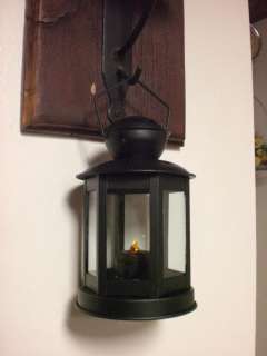 This is a primitive black lantern that measures 7 1/2 inches tall by 4 