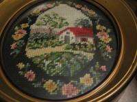 pair oval framed needlepoint pictures of houses with black border,deep 