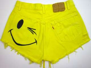   yellow dyed with winking smiley printed on back with the pocket ripped