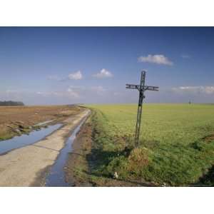 Christian Calvary Beside Muddy Track and Fields in Landscape Near 