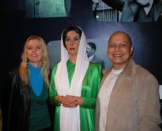 My husband and I at Madame Tussauds in London, with Benazir Bhuttos 