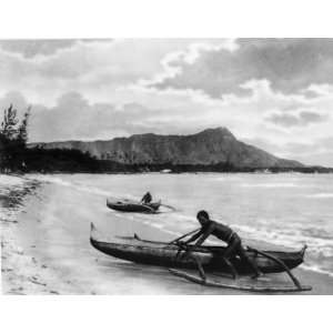   Natives with outrigger canoes at shoreline, Honolulu